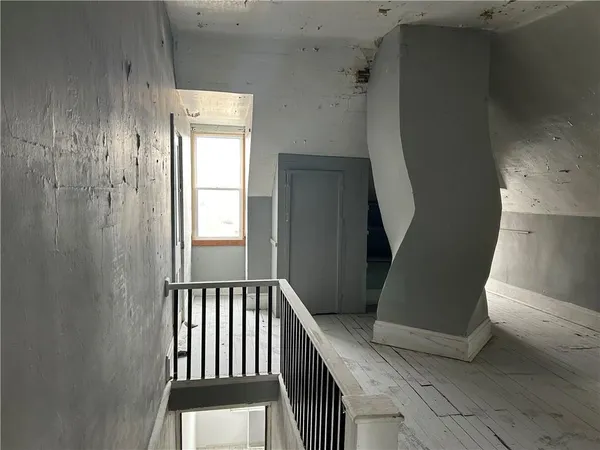 a view of a hallway view with staircase