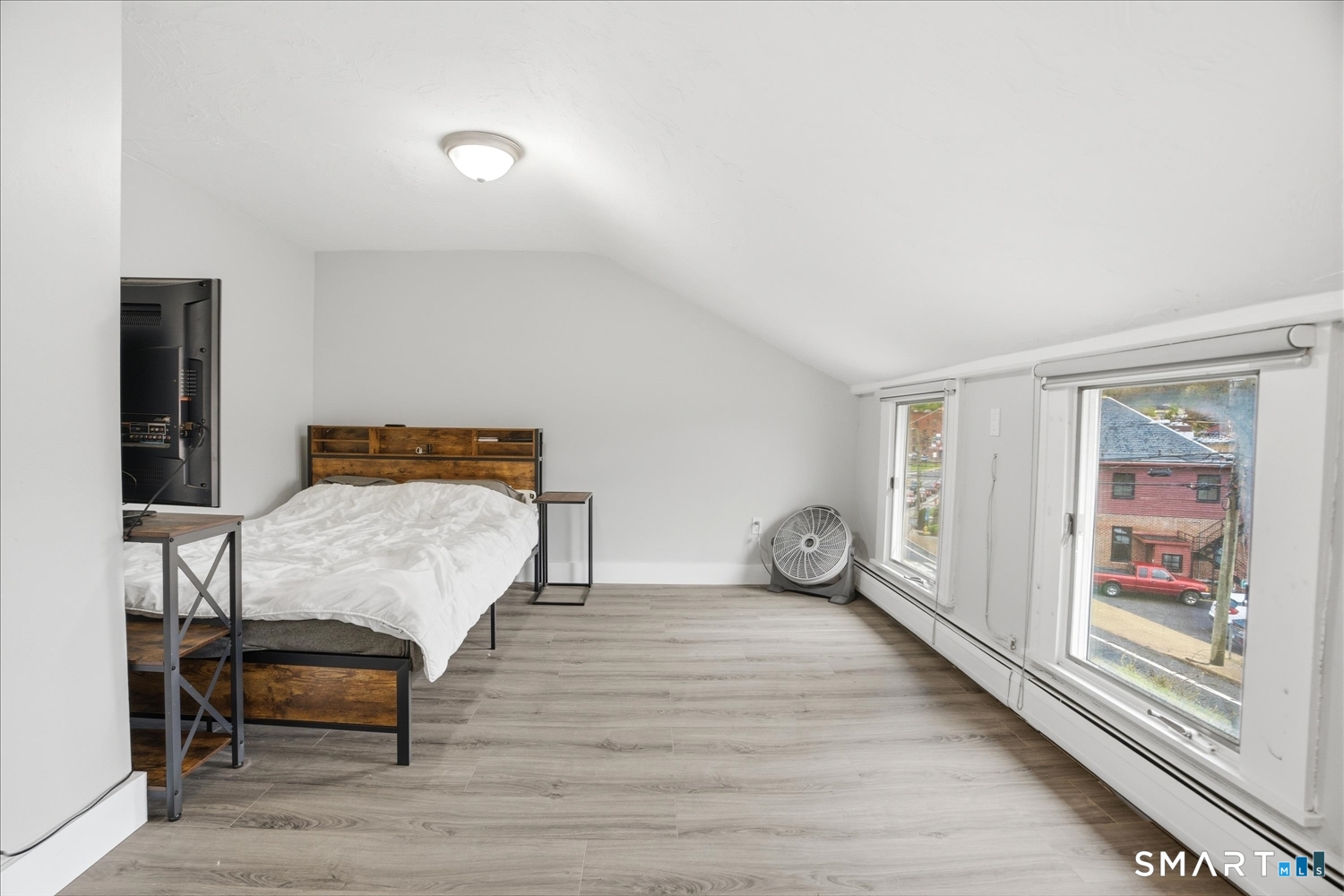 67 Pomfret Street Putnam, CT 06260 - Photo 12 of 25 a bedroom with a bed and wooden floor