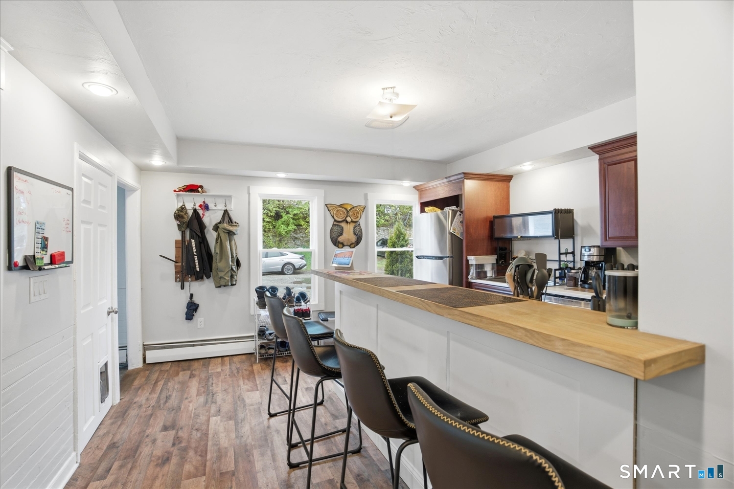 67 Pomfret Street Putnam, CT 06260 - Photo 3 of 25 a kitchen with a table chairs refrigerator and furniture