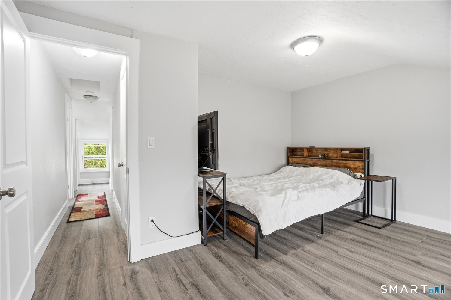 67 Pomfret Street Putnam, CT 06260 - Photo 10 of 25 a bedroom with a bed and wooden floor