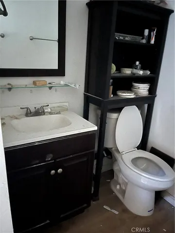 a bathroom with a sink toilet and mirror