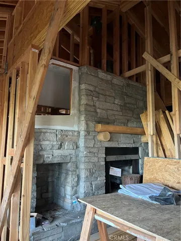 a view of an empty room with furniture and a window