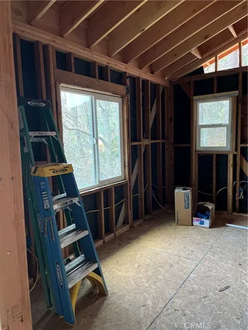 a view of a patio with table and chairs and wooden floor