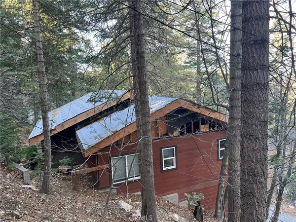 a front view of a house with a trees