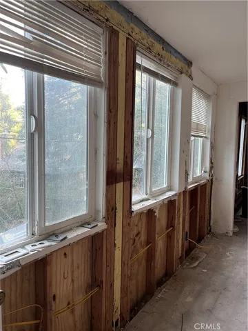 a view of a large room with wooden floor and windows