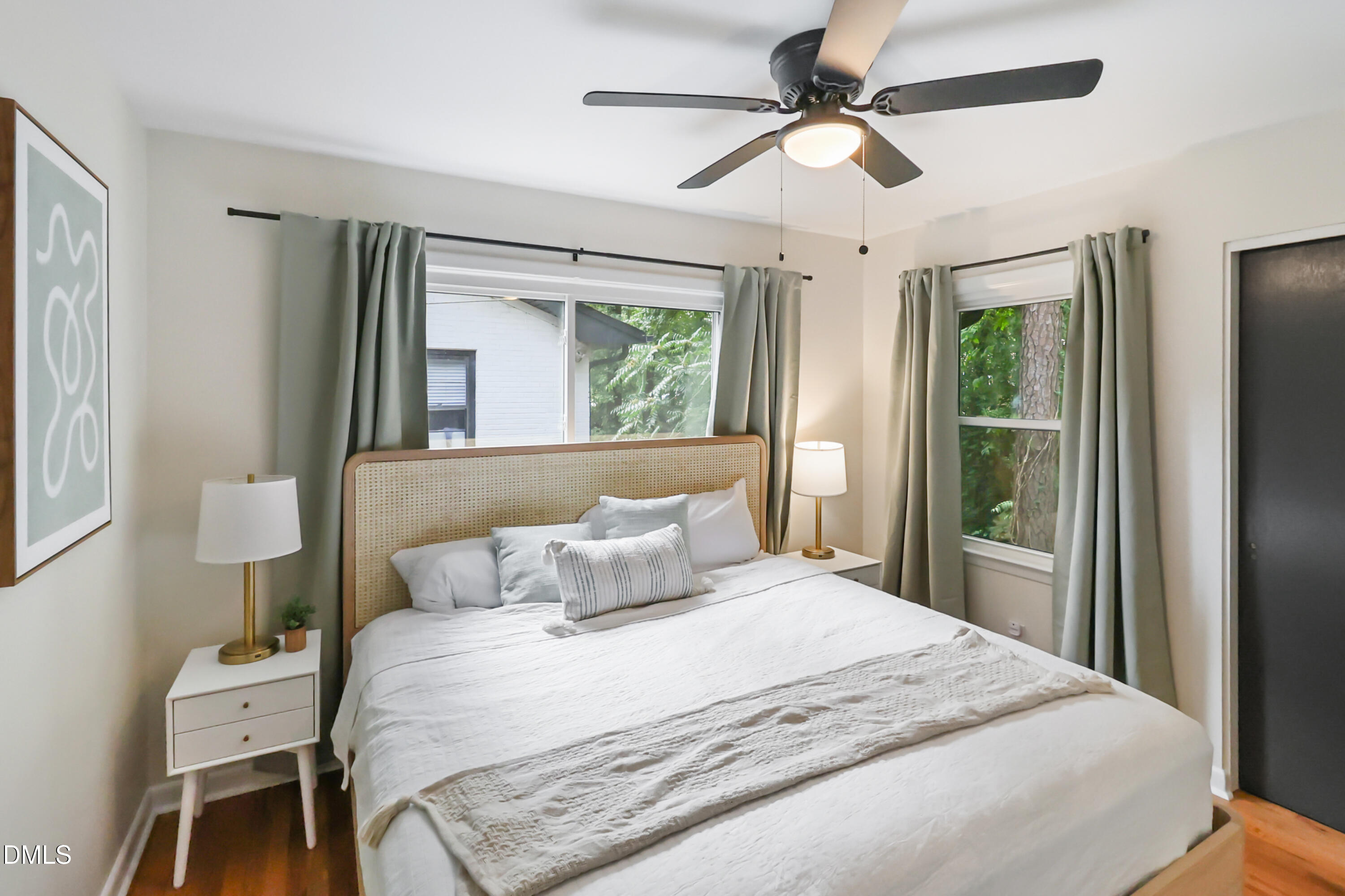 115 Bertie Drive Raleigh, NC 27610 - Photo 12 of 27 a bedroom with a large bed and a chandelier