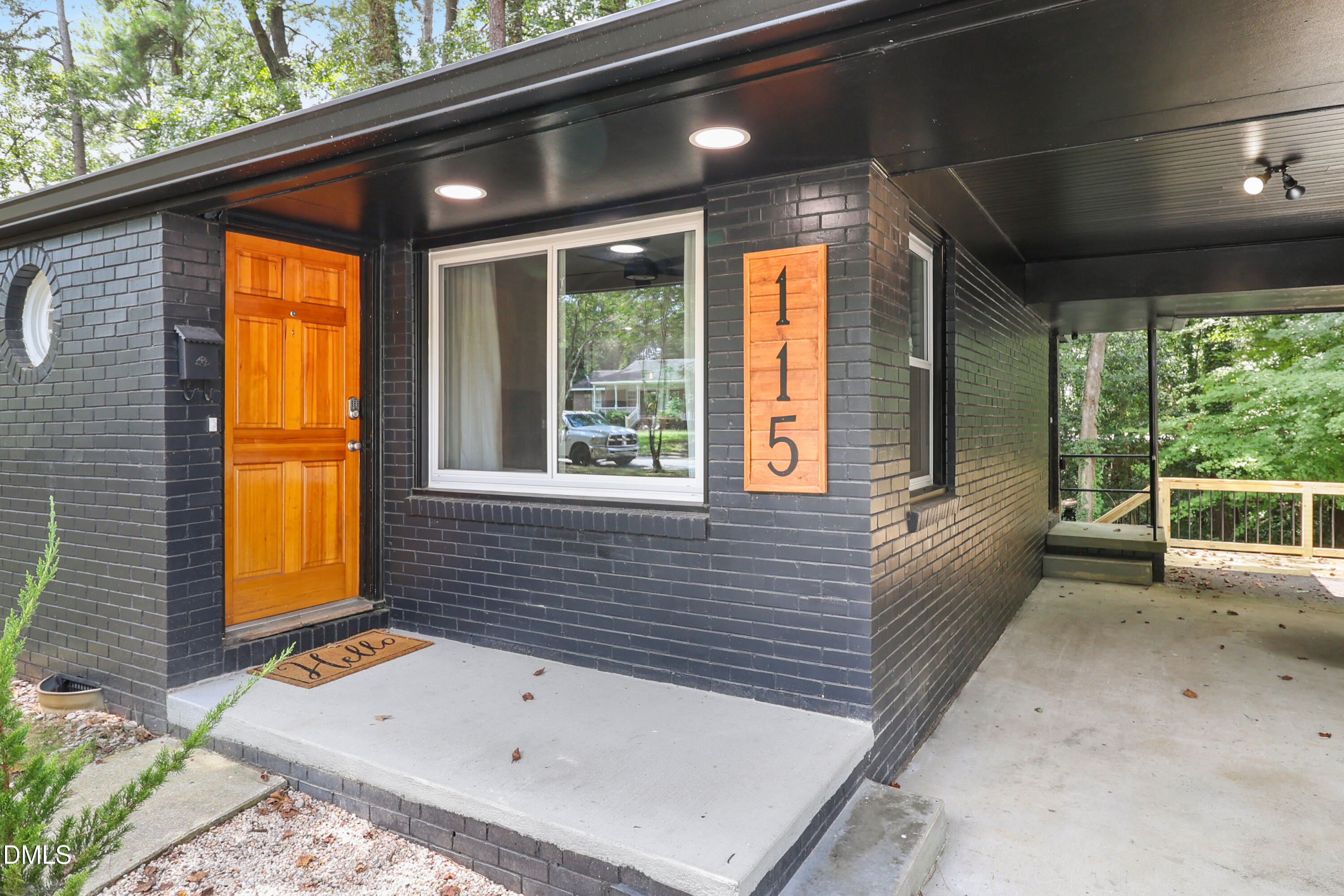 115 Bertie Drive Raleigh, NC 27610 - Photo 3 of 27 a view of a porch with a table and chairs
