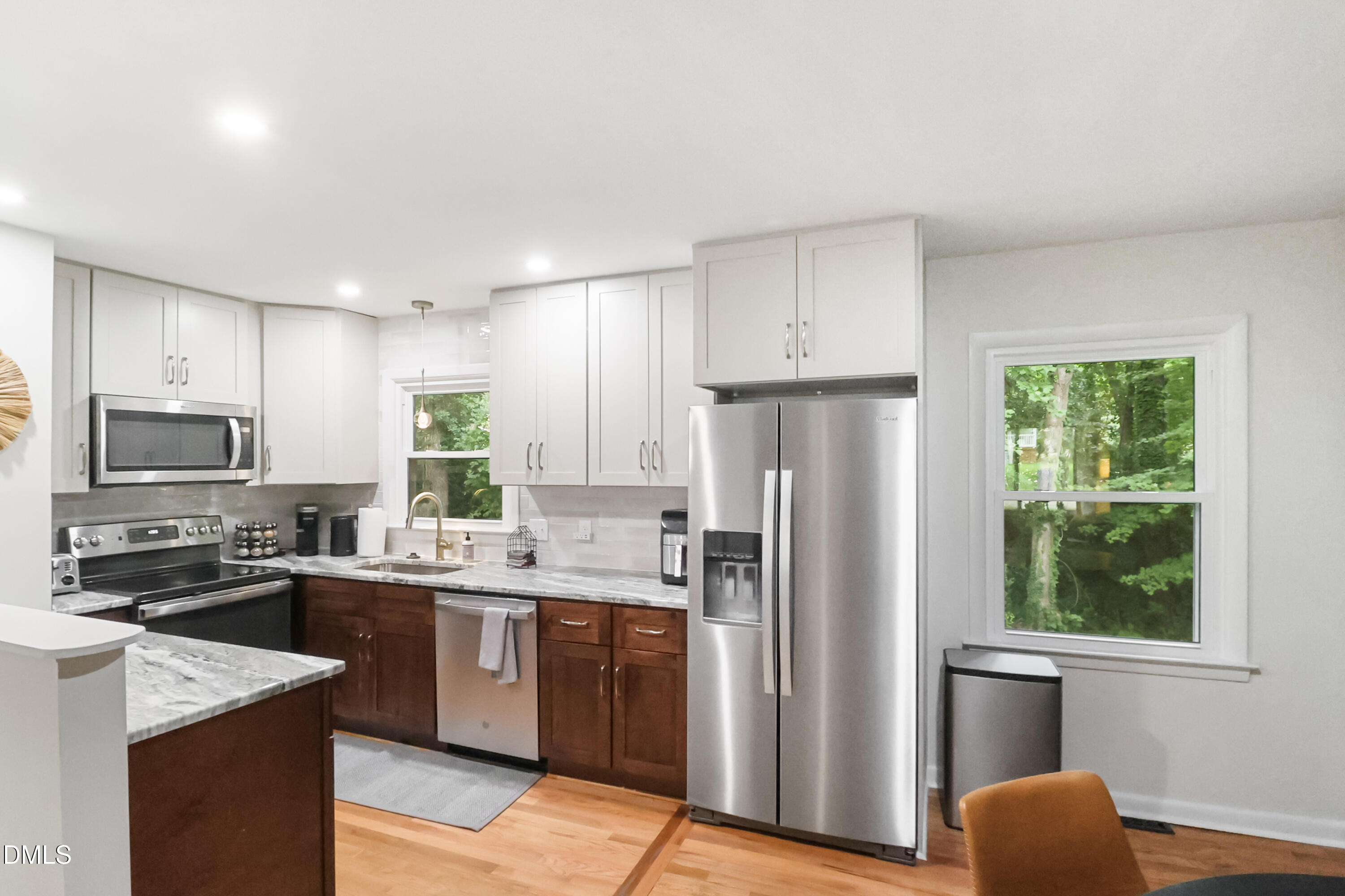 115 Bertie Drive Raleigh, NC 27610 - Photo 8 of 27 a kitchen with a refrigerator a sink a stove a microwave and wooden cabinets