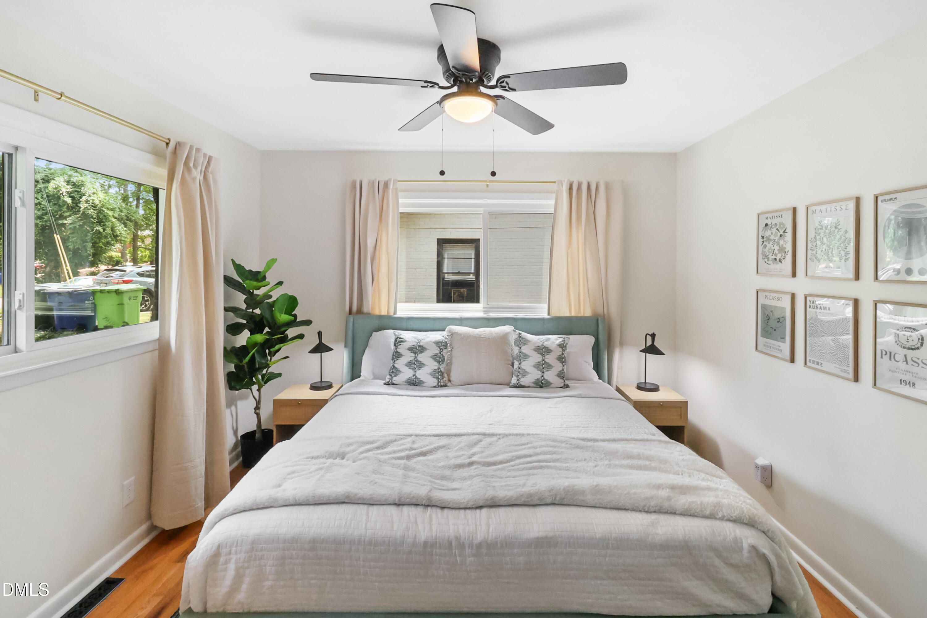 115 Bertie Drive Raleigh, NC 27610 - Photo 9 of 27 a bedroom with a large bed and a chandelier