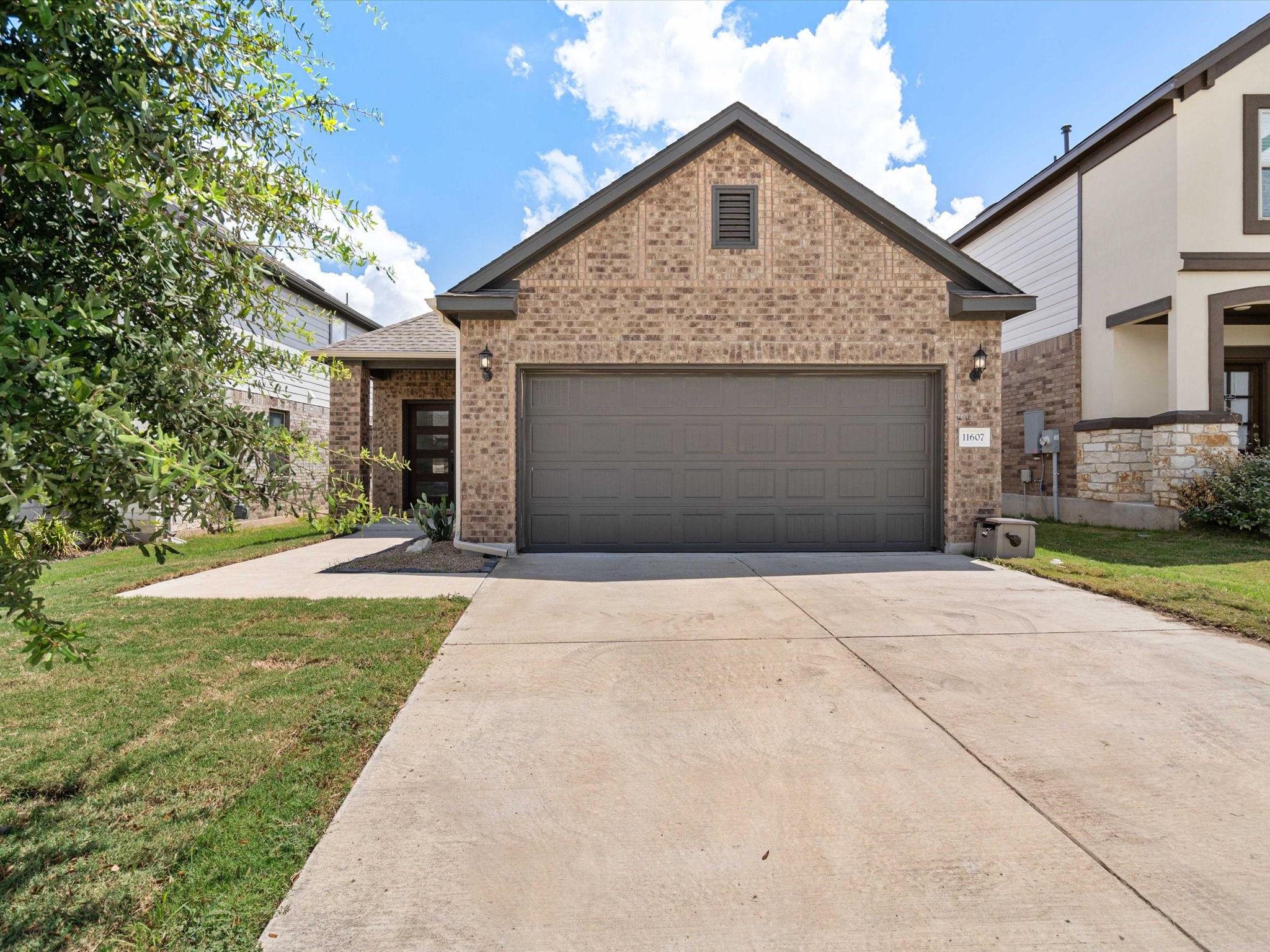 11607 Caithness Way Manor, TX 78653 - Photo 1 of 1 a front view of a house with a yard and garage