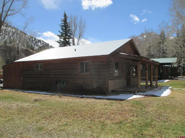 a view of a house with wooden fence
