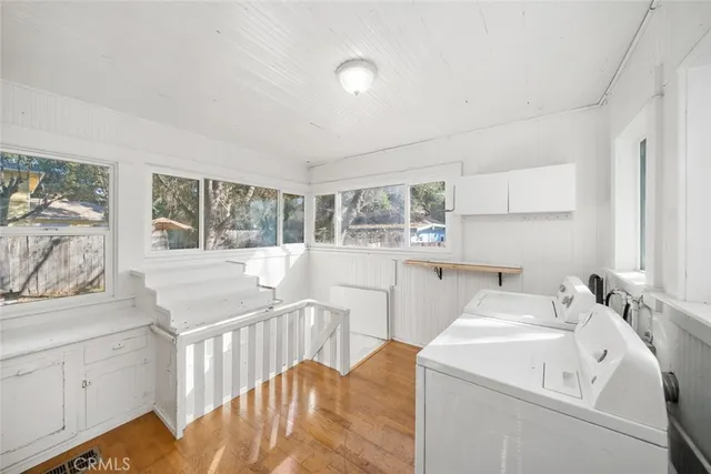 a view of a house with a large window and wooden fence