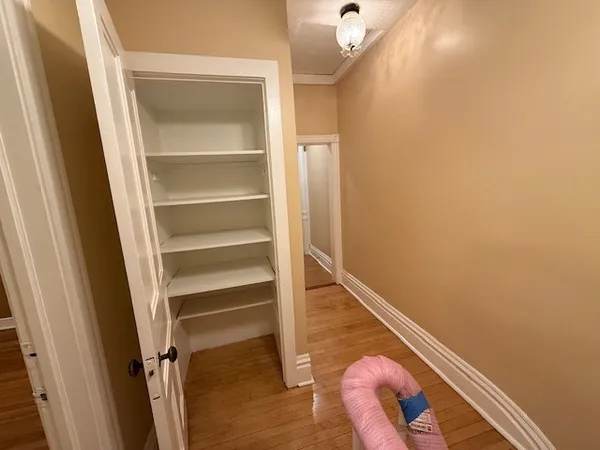 a room with a wooden floor and white walls