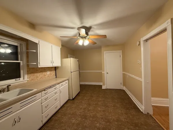a kitchen with cabinets and window