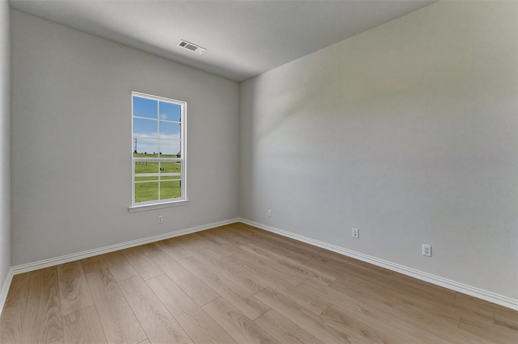 114 Hillview Trail Decatur, TX 76234 - Photo 9 of 27 Bright room featuring wood-finish flooring and a window with a white frame