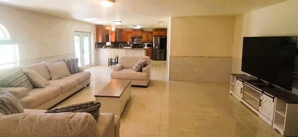 a view of a porch with wooden floor and garden