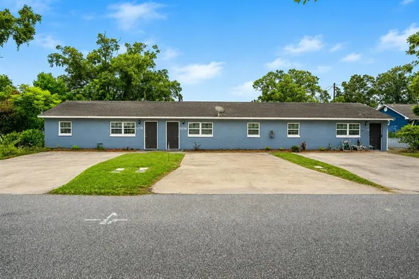 a house with green field in front of it