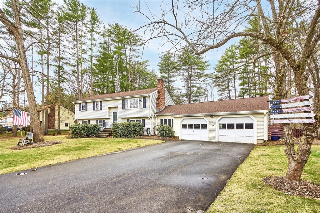 a view of residential houses with yard and trees