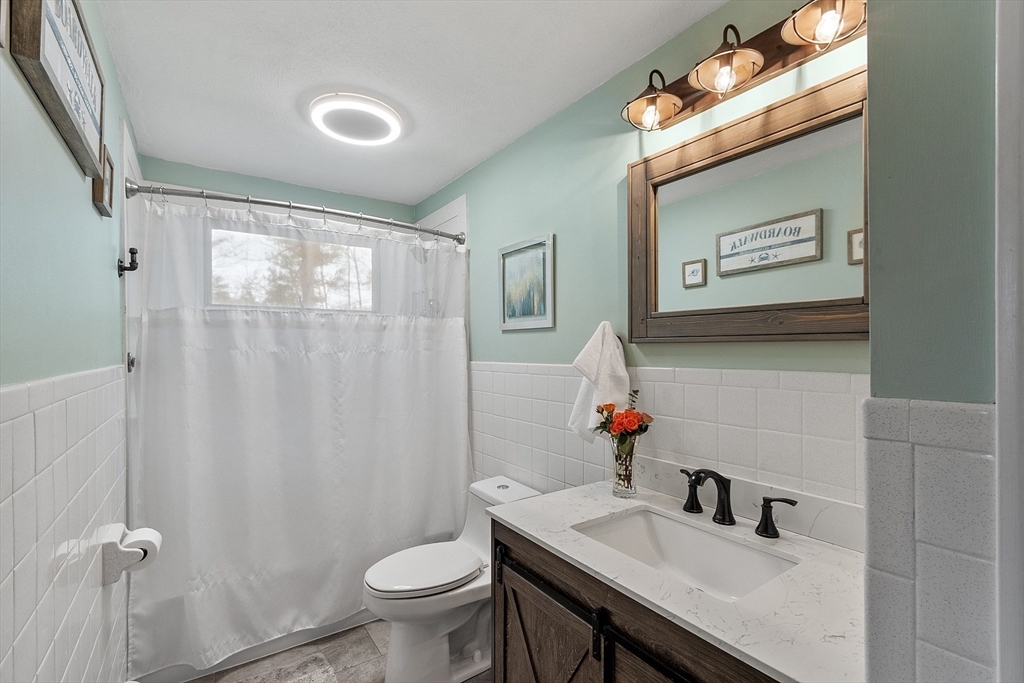 16 Michael Road Maynard, MA 01754 - Photo 15 of 39 a bathroom with a sink vanity mirror and toilet