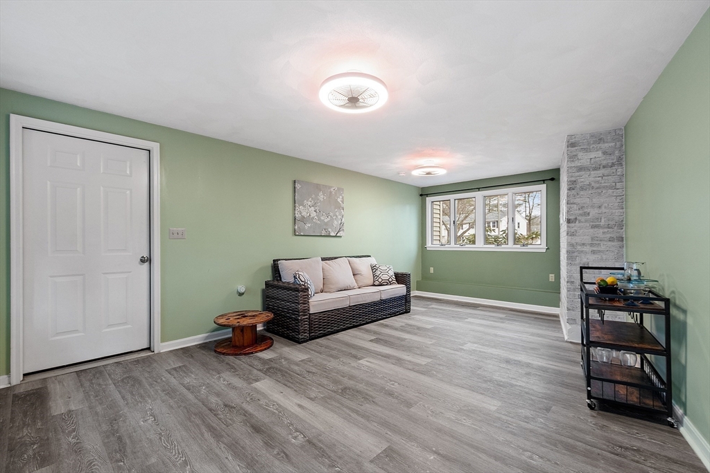 16 Michael Road Maynard, MA 01754 - Photo 25 of 39 a living room with furniture and a wooden floor