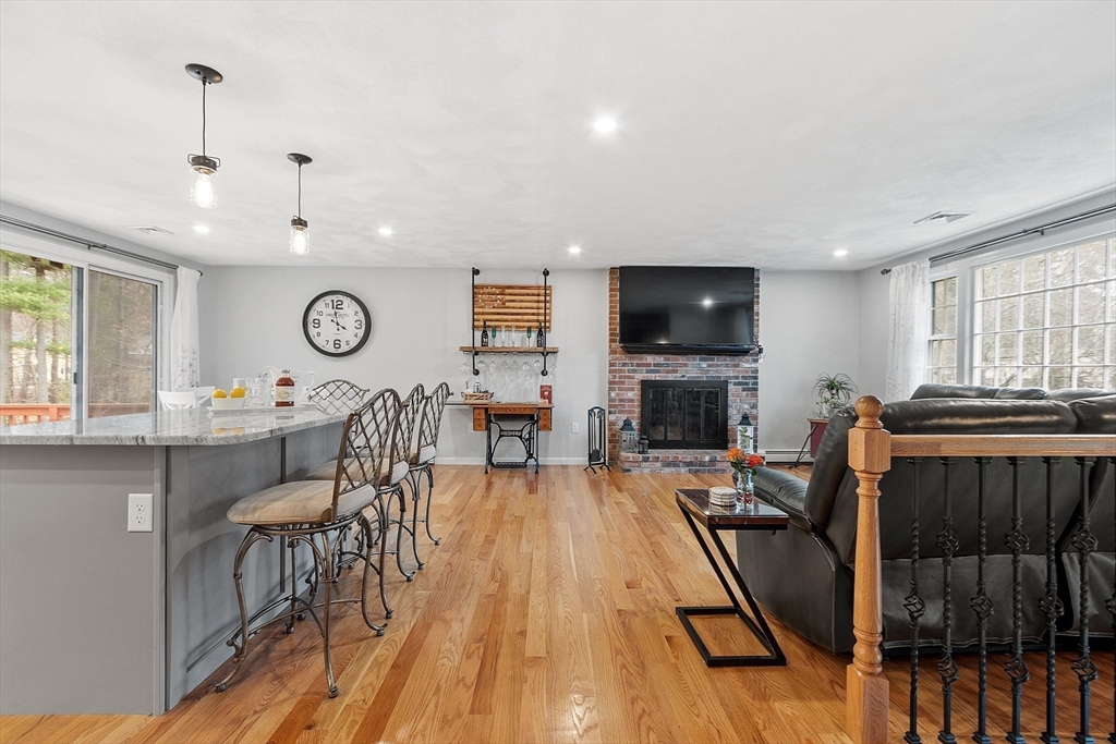 16 Michael Road Maynard, MA 01754 - Photo 7 of 39 a living room with furniture a fireplace and a flat screen tv