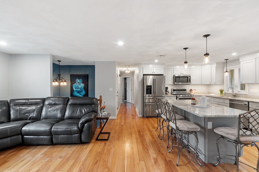 16 Michael Road Maynard, MA 01754 - Photo 8 of 39 a living room with stainless steel appliances kitchen island granite countertop furniture and a wooden floor