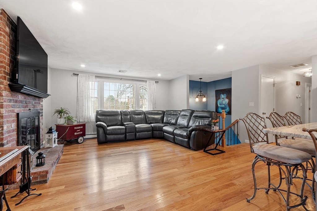 16 Michael Road Maynard, MA 01754 - Photo 9 of 39 a living room with fireplace furniture and a flat screen tv