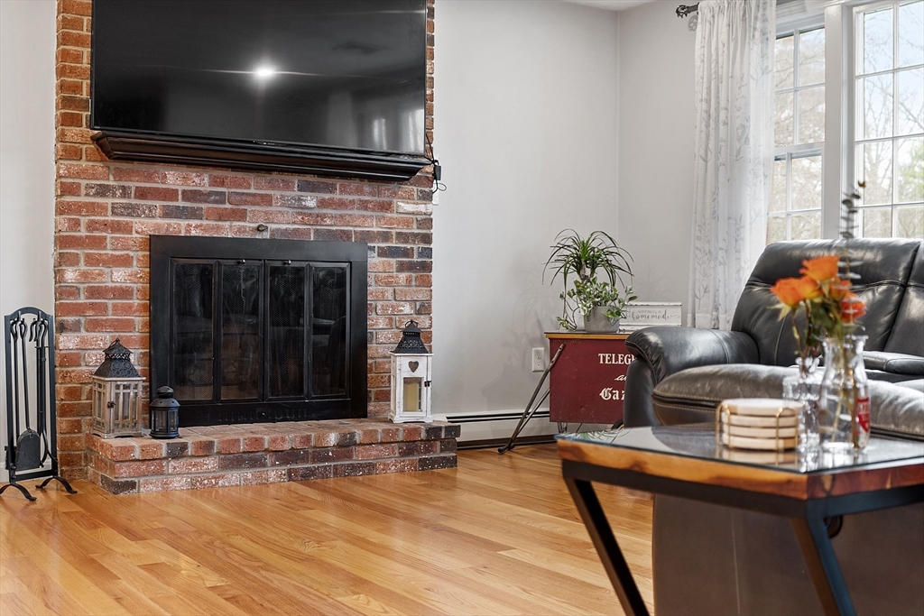 16 Michael Road Maynard, MA 01754 - Photo 10 of 39 a living room with fireplace furniture and a flat screen tv