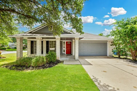a front view of house with yard and green space