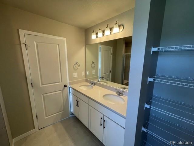 534 Ryan Avenue Fort Lupton, CO 80621 - Photo 16 of 25 a bathroom with a sink and a mirror