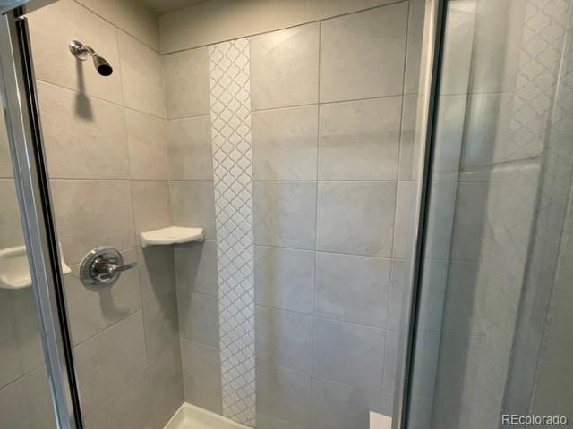 534 Ryan Avenue Fort Lupton, CO 80621 - Photo 17 of 25 a bathroom with a shower and a toilet
