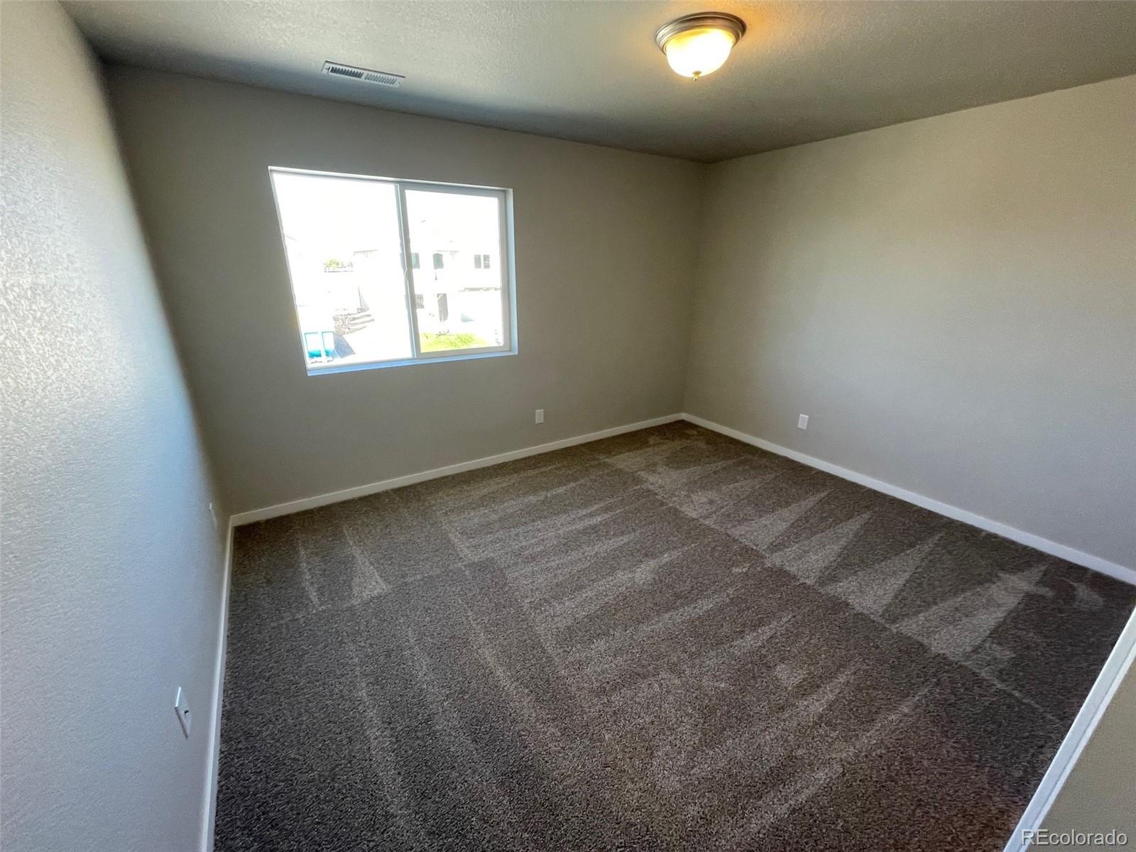 534 Ryan Avenue Fort Lupton, CO 80621 - Photo 20 of 25 an empty room with windows