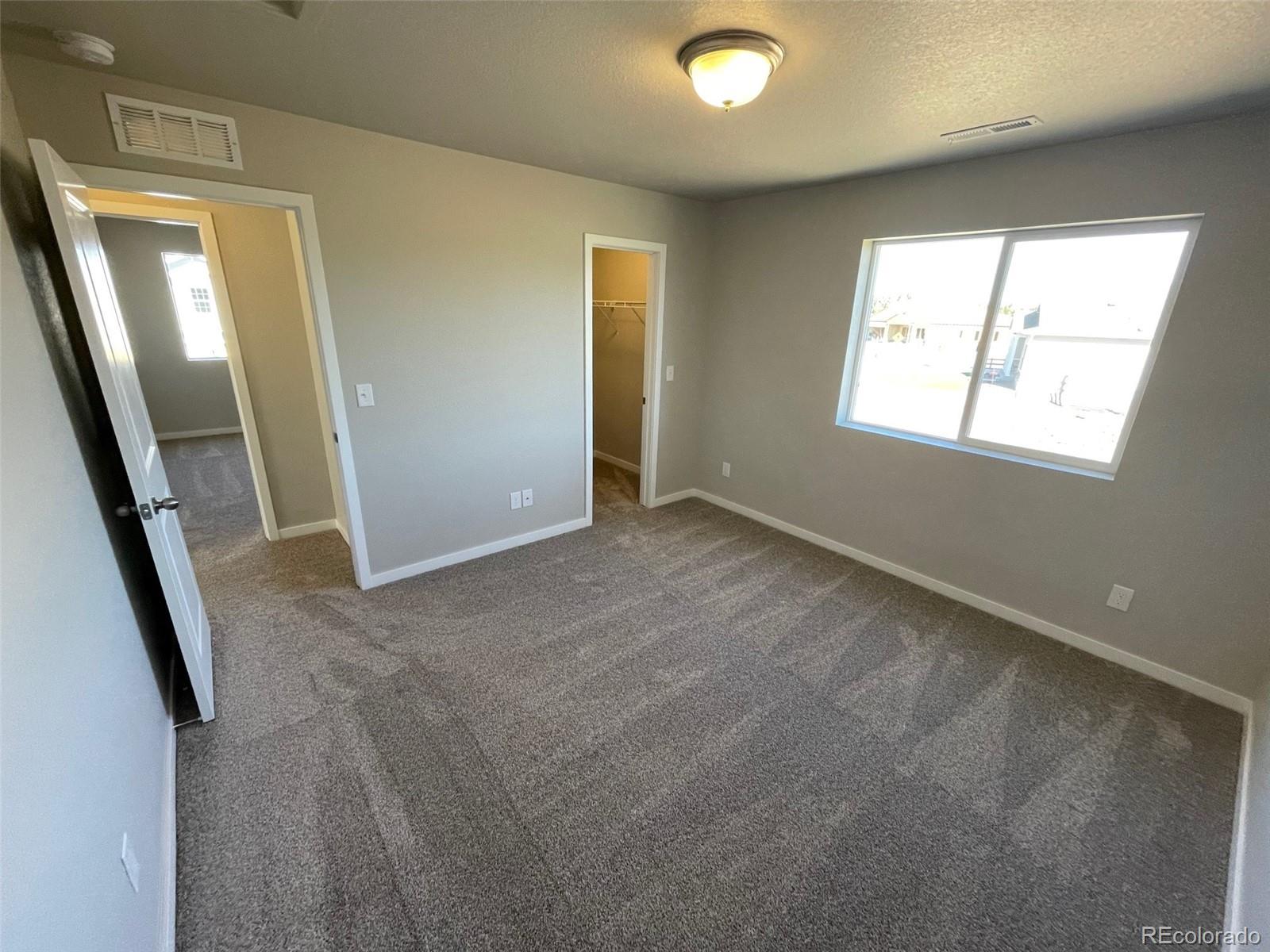 534 Ryan Avenue Fort Lupton, CO 80621 - Photo 21 of 25 an empty room with windows and closet