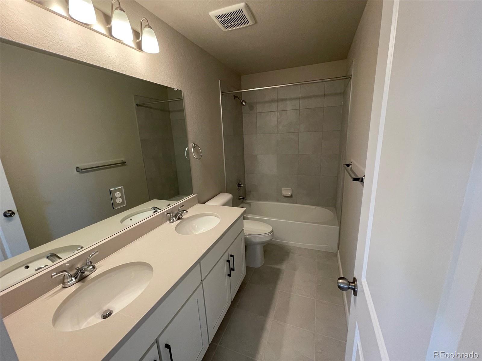 534 Ryan Avenue Fort Lupton, CO 80621 - Photo 24 of 25 a bathroom with a double vanity sink mirror double and shower