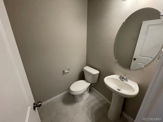 534 Ryan Avenue Fort Lupton, CO 80621 - Photo 6 of 25 a bathroom with a toilet sink and mirror