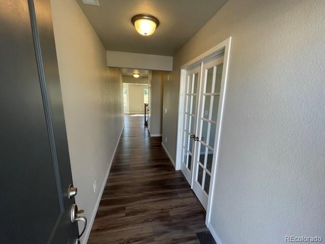 534 Ryan Avenue Fort Lupton, CO 80621 - Photo 7 of 25 a view of a hallway with wooden floor and staircase