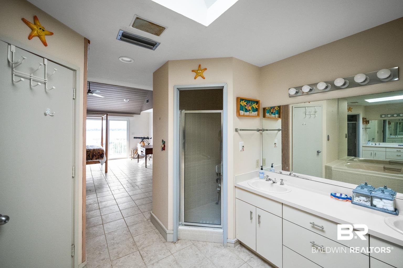 29255 Ono Boulevard Orange Beach, AL 36561 - Photo 34 of 43 Bathroom featuring vanity, tile patterned floors, and a shower stall