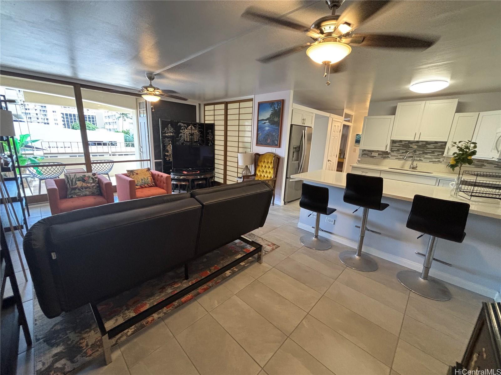 a living room with furniture a flat screen tv and a large window