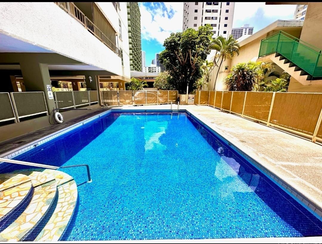 225 Kaʻiulani Avenue, Unit 402 Honolulu, HI 96815 - Photo 16 of 16 a view of a backyard with swimming pool
