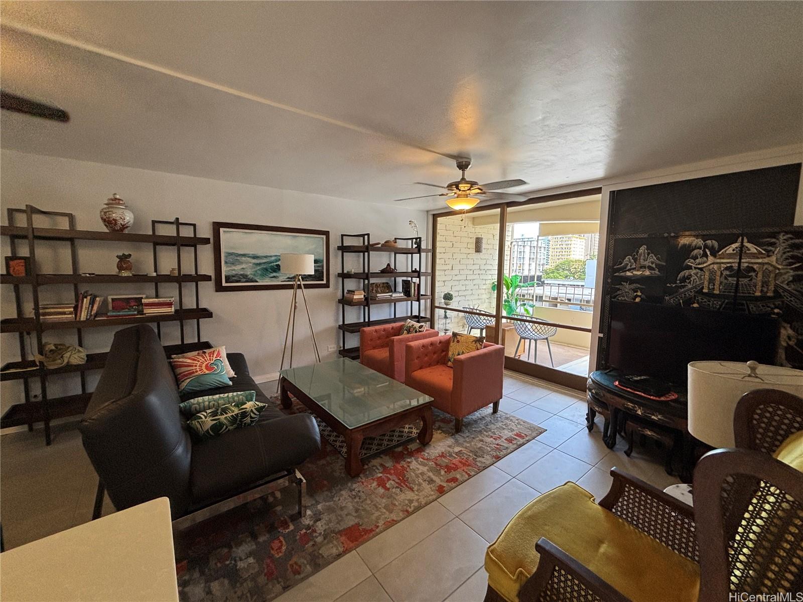 225 Kaʻiulani Avenue, Unit 402 Honolulu, HI 96815 - Photo 2 of 16 a living room with furniture and a floor to ceiling window