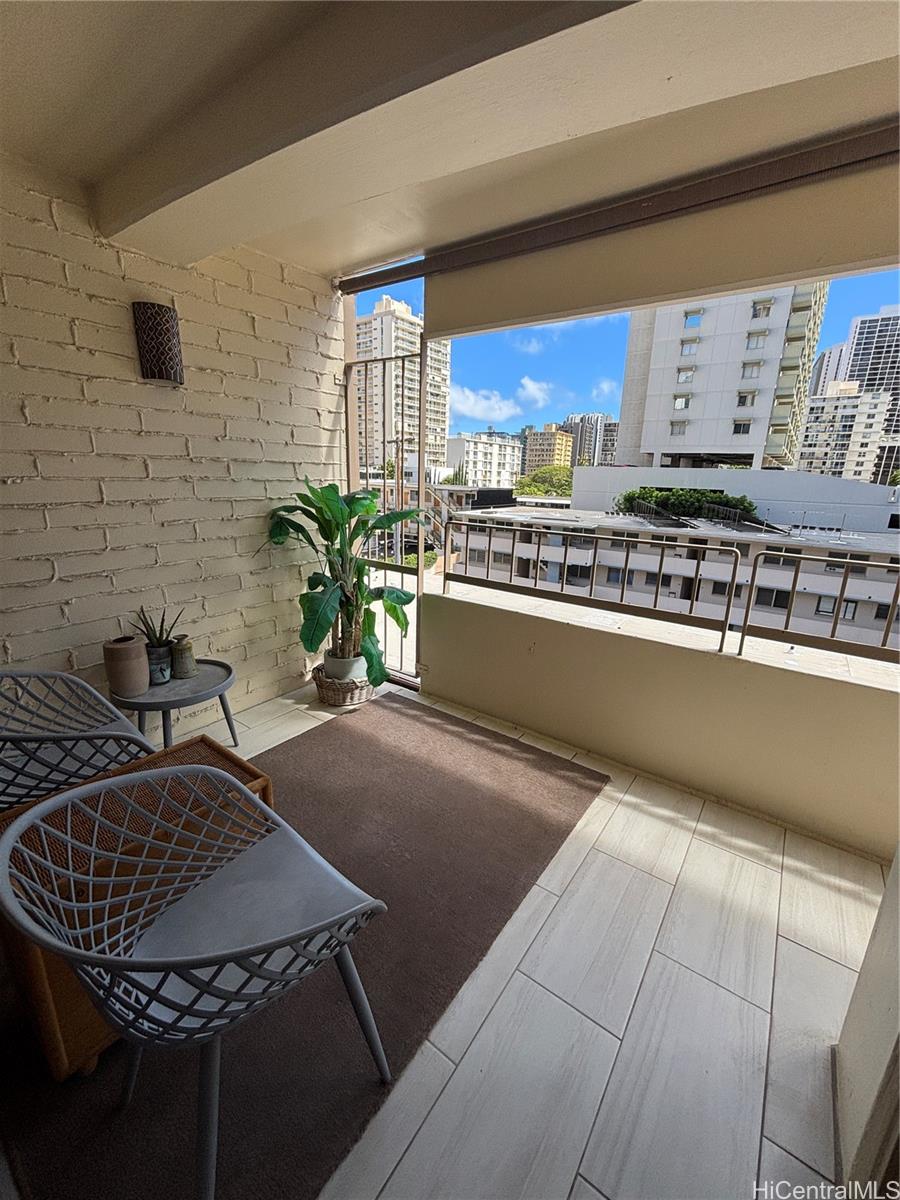 225 Kaʻiulani Avenue, Unit 402 Honolulu, HI 96815 - Photo 4 of 16 a kitchen with a sink and a stove top oven