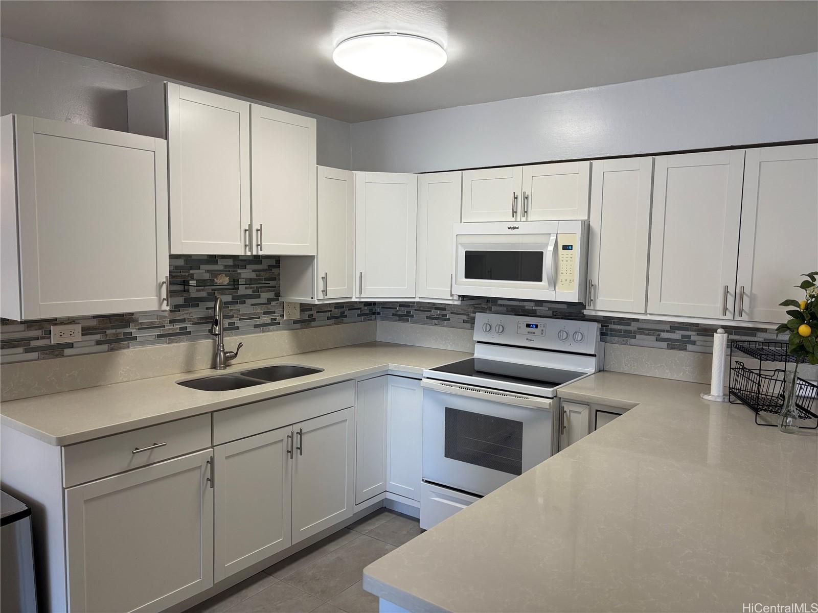 225 Kaʻiulani Avenue, Unit 402 Honolulu, HI 96815 - Photo 7 of 16 a kitchen with cabinets appliances and a sink