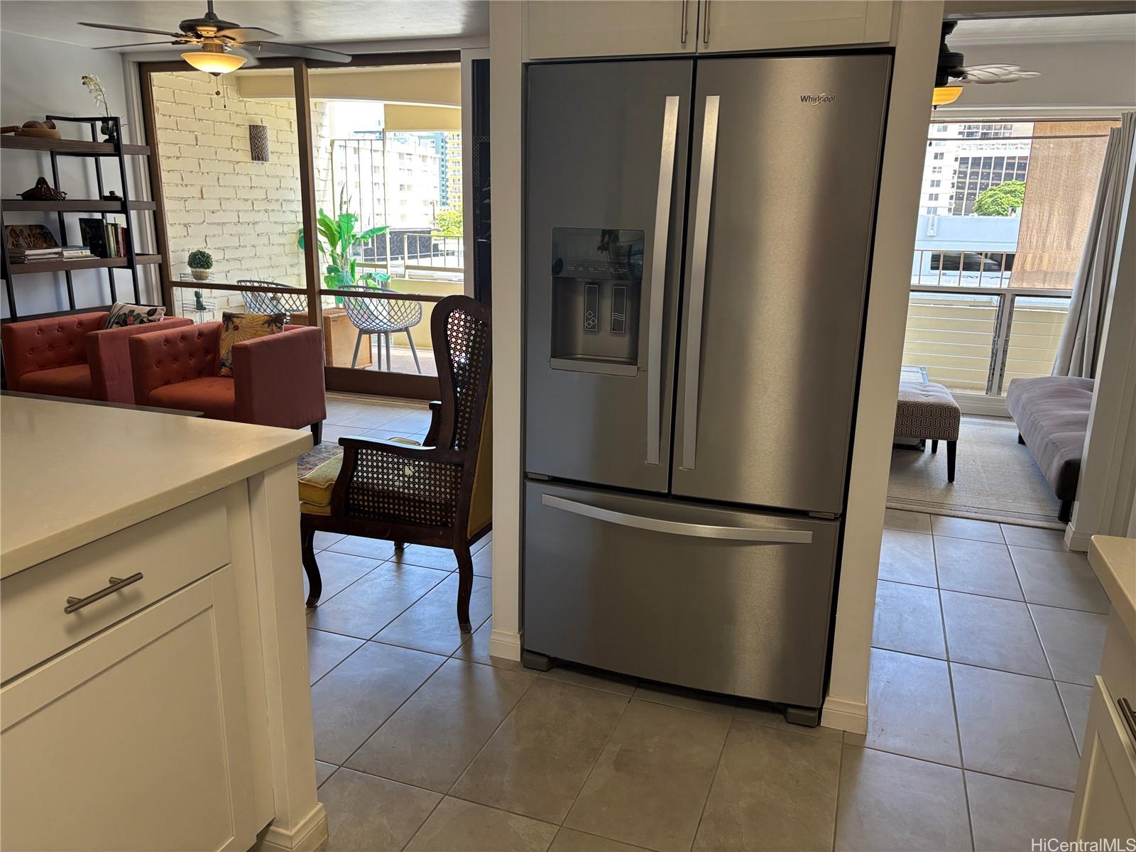 225 Kaʻiulani Avenue, Unit 402 Honolulu, HI 96815 - Photo 8 of 16 a kitchen with stainless steel appliances a refrigerator sink and cabinets