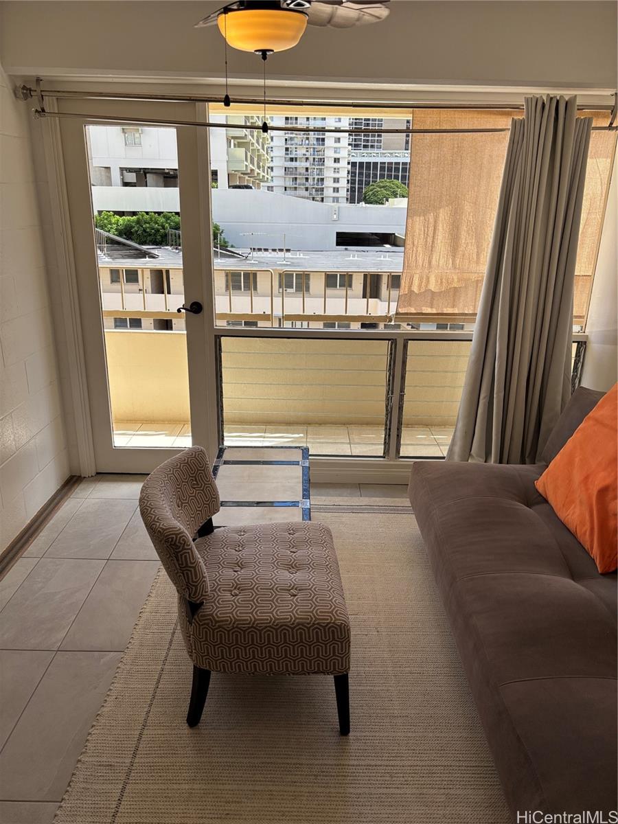 225 Kaʻiulani Avenue, Unit 402 Honolulu, HI 96815 - Photo 10 of 16 a living room with furniture and a window