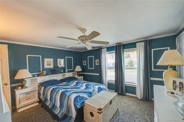 a spacious bedroom with a bed and wooden floor