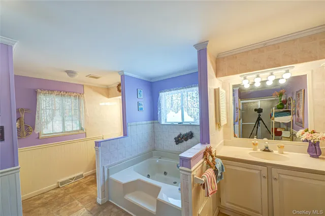 a bathroom with a sink mirror and a bathtub