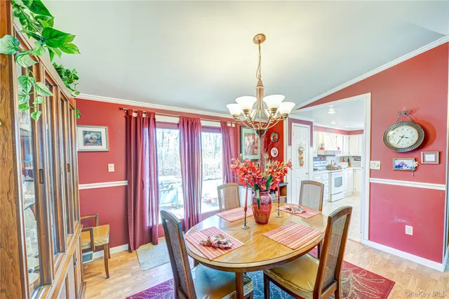 a view of a dining room with furniture and chandelier