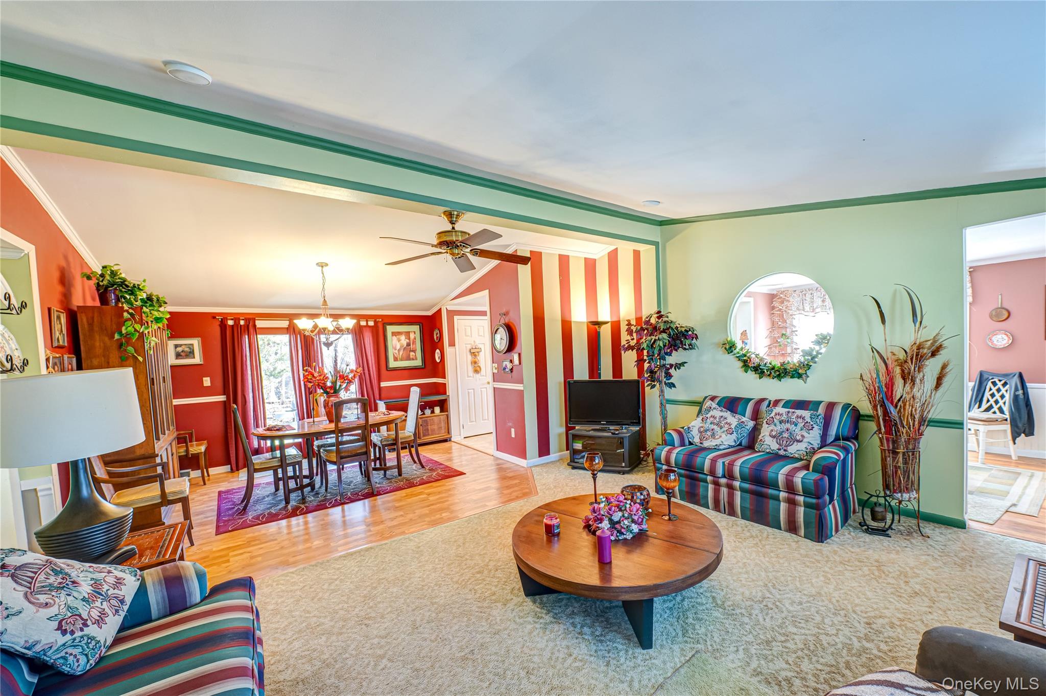 1407 Middle Road, Unit 6 Calverton, NY 11933 - Photo 6 of 25 a living room with furniture and a dining table