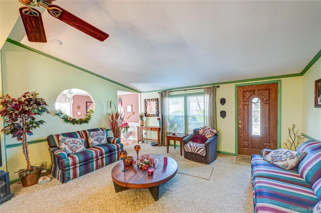 a living room with furniture and flowers
