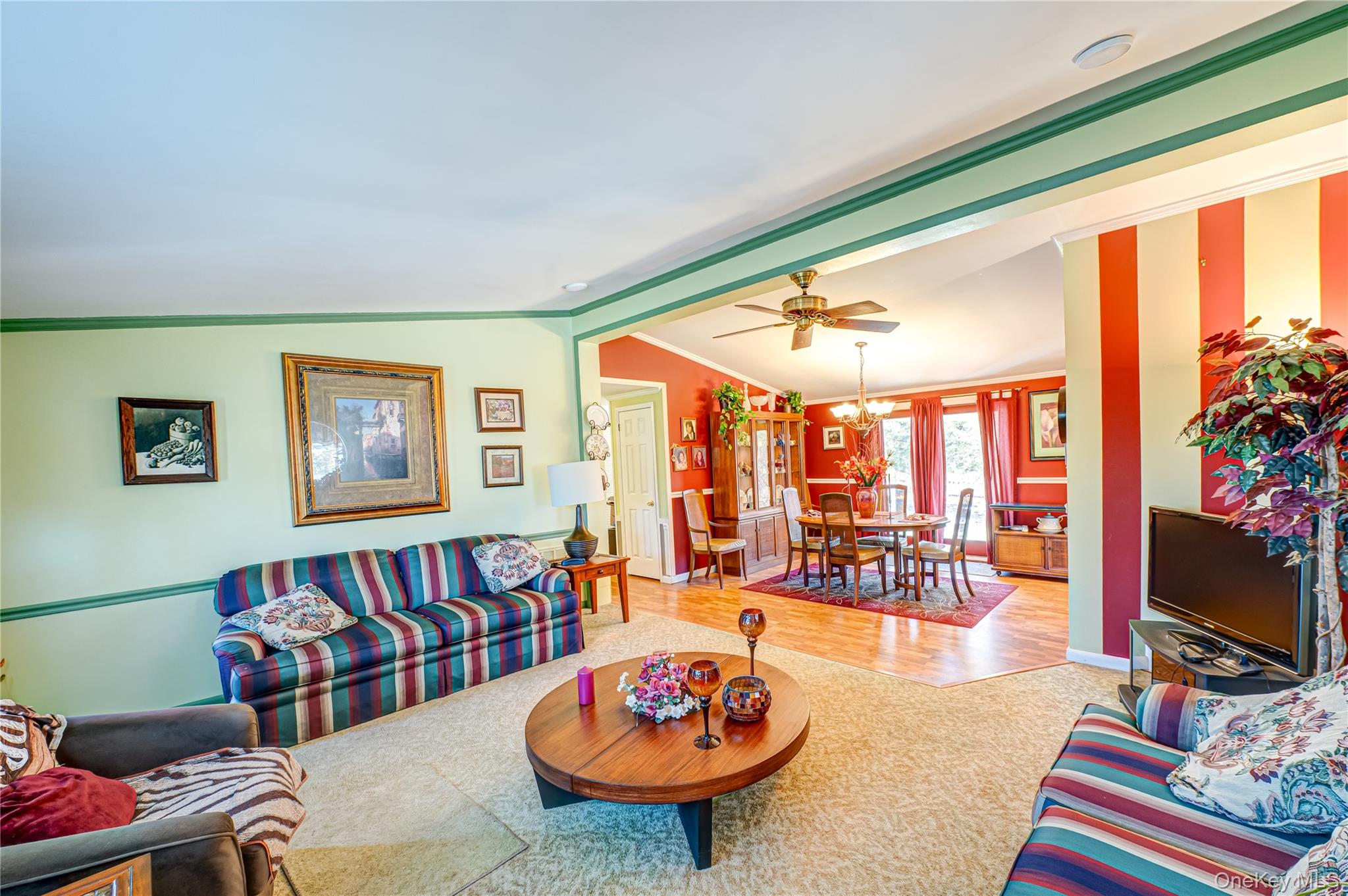 1407 Middle Road, Unit 6 Calverton, NY 11933 - Photo 8 of 25 a living room with furniture a flat screen tv and a floor to ceiling window